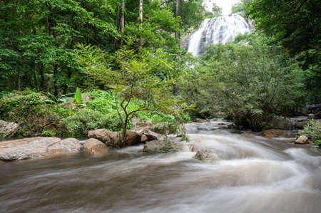 A beautiful waterfall deep in the tropical forest, steep mountain adventure in the rainforest.