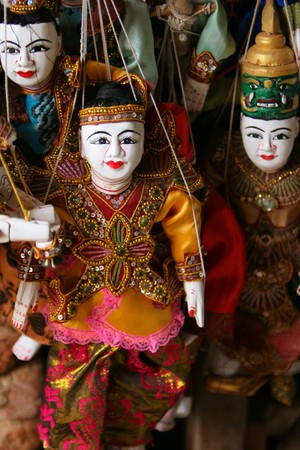 a selection of wooden burmese puppets in traditional costumeの写真素材