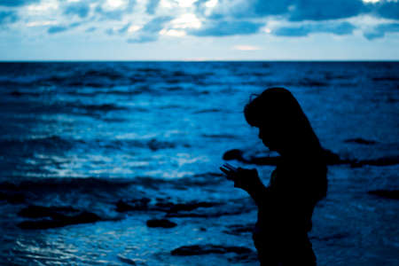 silhouettes of young girl on a beach