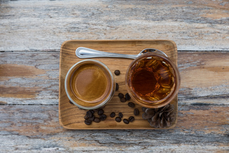 Drip coffee and hot tea ready for serve on the wood tray and decorated by seeds coffee and seed pine treeの写真素材