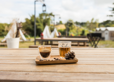 Drip coffee and hot tea ready for serve on the wood tray and decorated by seeds coffee and seed pine treeの写真素材
