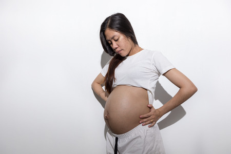 Teenager girl be pregnant in education age in white suit on isolated background