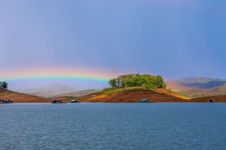 The beautiful rainbow show on rainy stop over the mountains and raft in lake