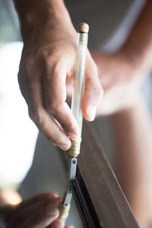 Technicians are using cutting tools, cut glass according to customer size