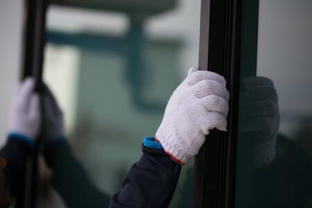 The technician's hands will install aluminum windows.の写真素材