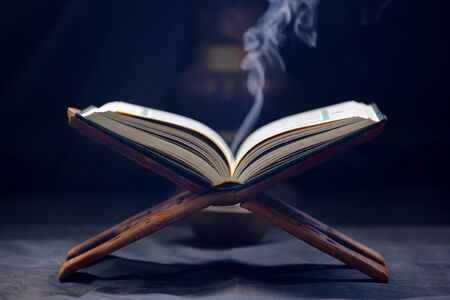 Quran - Muslim holy book placed on a wooden boardの写真素材