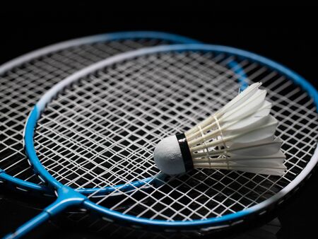 Badminton shuttlecock and badminton racket in the black background used in competitionの写真素材