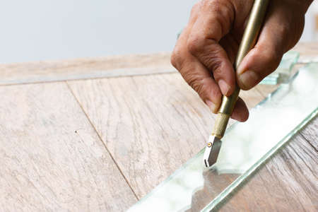 Technicians are using cutting tools, cut glass according to customer sizeの写真素材