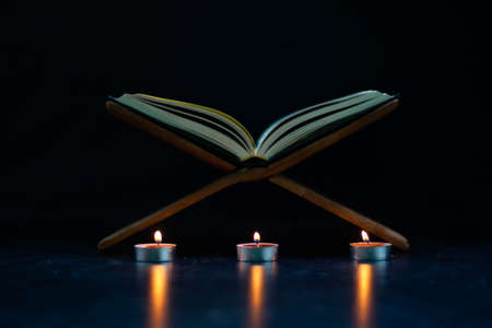 Quran in the mosque - open for prayers The black background of the Muslims around the world placed on a wooden board Quran in the mosque - open for prayersの写真素材