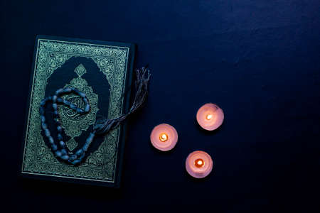 Quran in the mosque - open for prayers The black background of the Muslims around the world placed on a wooden board Quran in the mosque - open for prayersの写真素材