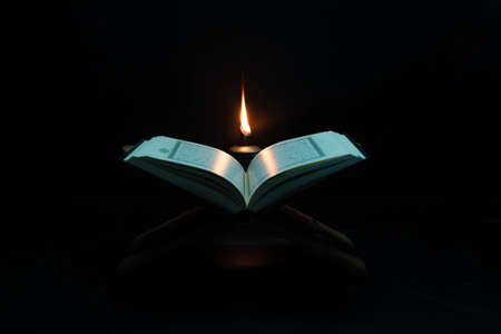 Quran in the mosque - open for prayers The black background of the Muslims around the world placed on a wooden board Quran in the mosque - open for prayersの写真素材