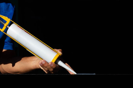 Craftsmen are using silicone adhesives for general and industrial applications.の写真素材