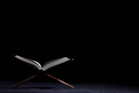 Quran in the mosque - open for prayers The black background of the Muslims around the world placed...