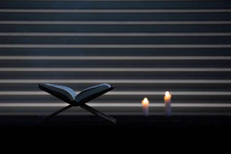 Quran in the mosque - open for prayers The black background of the Muslims around the world placed...