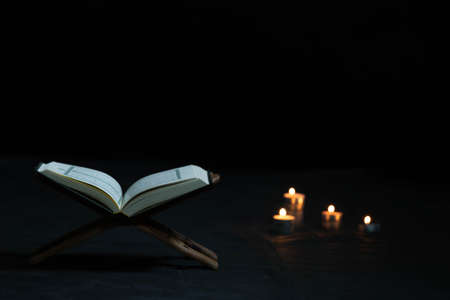 Quran in the mosque - open for prayers The black background of the Muslims around the world placed on a wooden board Quran in the mosque - open forの写真素材