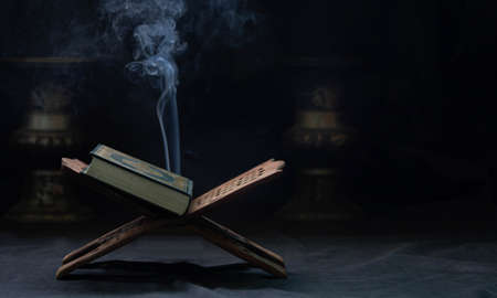Quran in the mosque - open for prayers The black background of the Muslims around the world placed on a wooden board Quran in the mosque - open for prayersの写真素材