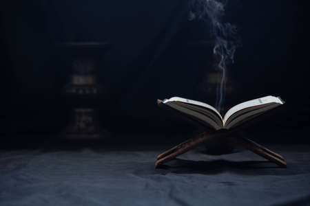 Quran in the mosque - open for prayers The black background of the Muslims around the world placed...