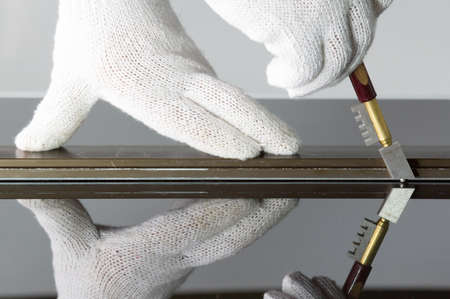 Glass technicians are cutting glass using glass tools according to the customer's order.