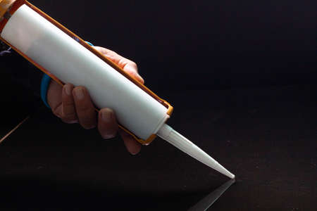 Craftsmen are using silicone adhesives for general and industrial applications. premium acetoxy silicone sealantの写真素材