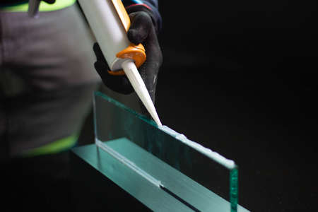 Craftsmen are using silicone adhesives for general and industrial applications. premium acetoxy silicone sealantの写真素材