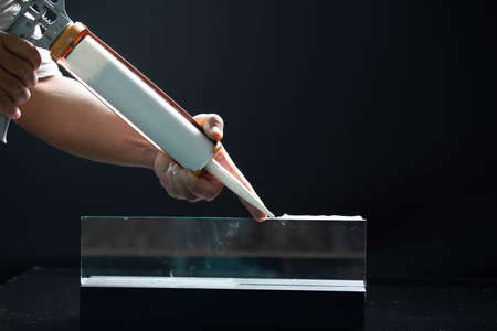 Craftsmen are using silicone adhesives for general and industrial applications. premium acetoxy silicone sealantの写真素材