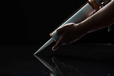 Craftsmen are using silicone adhesives for general and industrial applications. premium acetoxy silicone sealantの写真素材
