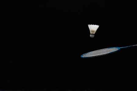 Badminton racket and shuttlecock isolated on a black background.の写真素材