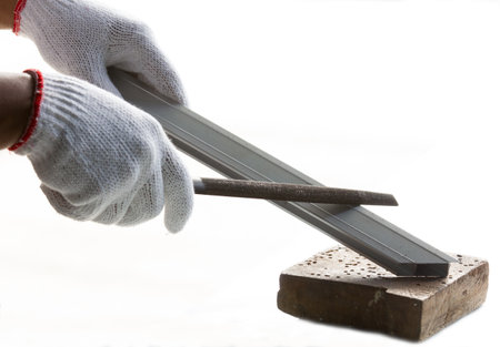 Worker hands in protective gloves holding a piece of wood on a white backgroundの写真素材