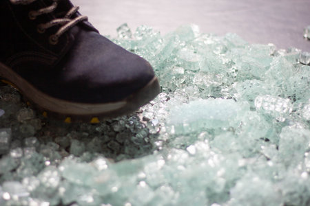 A lot of broken glass fell into safety shoes.の写真素材