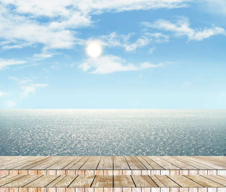 Sea and sky in the daytime and wood slabs arranged in perspective background for design.の写真素材