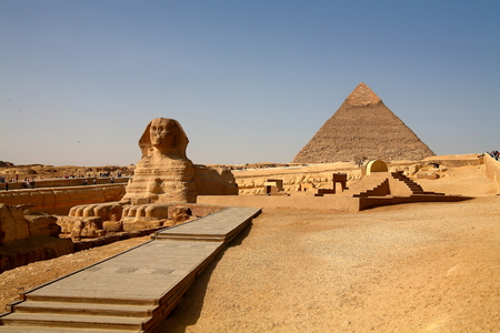 Sphinx in Cairo with pyramid at broad daylight