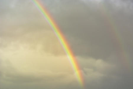 A bright rainbow in the sky, just after the rain, the sky and the rainbow