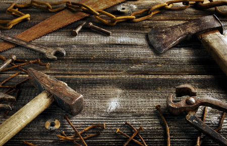 Rusty tools on old dark plank background with copyspaceの写真素材