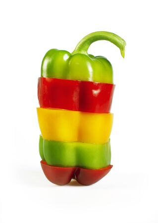 Paprika sliced isolated on white - red, yellow and green paprikaの写真素材