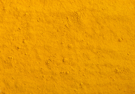 Turmeric powder texture. Yellow curcuma spice background.の写真素材