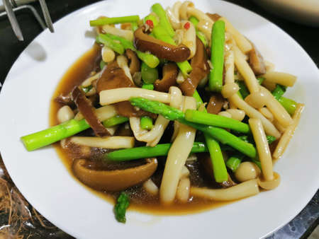 Mushroom stir fried with soy sauce and asparagus.の写真素材