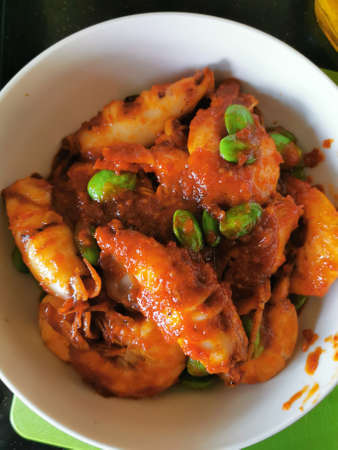 Spicy fried squid with sweet and sour sauce in white bowl.の写真素材