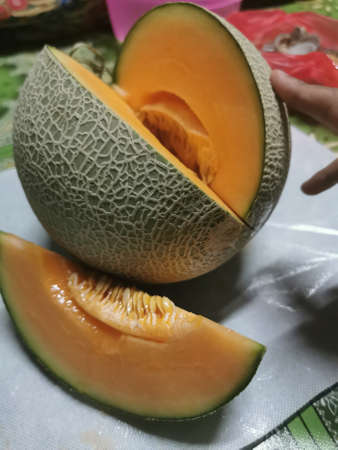 Melon, cantaloupe melon cut in half on a table
