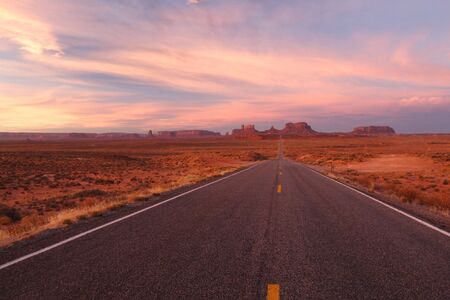 This is probably one of the mostly filmed or photographed road. It's sunrise at the Monument Valley の写真素材