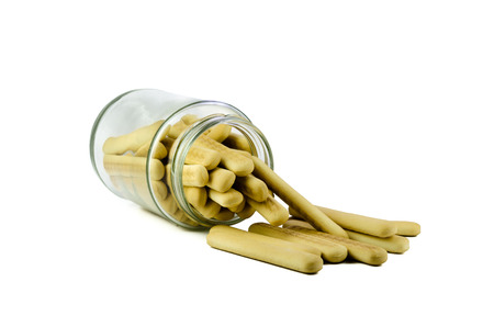 Mini crispy straw stored in glass jar isolated on white background