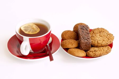 A cup of tea and delicious cookies on a plateの写真素材