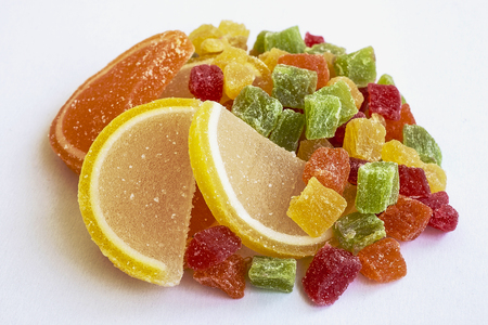 Food. Sweets. The tasty delightful multi-colored candied fruit in a plateの写真素材