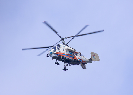 Air transport. The big helicopter flies in the blue sky