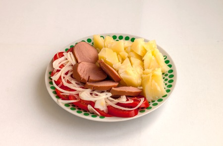 Food. Potato, a sausage and vegetables in a plateの写真素材