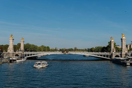 France. The bridge through the river. Tourist boatの写真素材