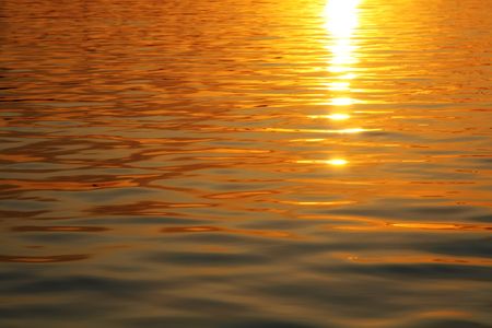 Sun path on sea's wave in sunsetの写真素材