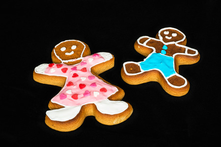 Gingerbread man, mother and son on black velvet in christmas