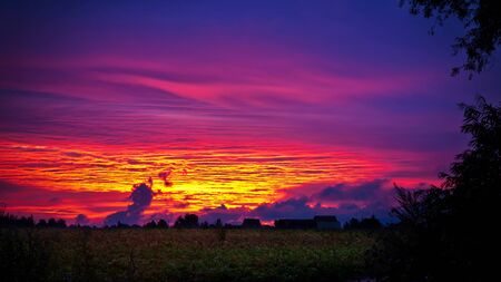 Glowing clouds after sunset in countrysideの写真素材
