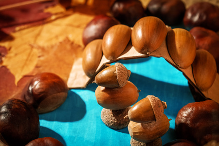 Figurines of ducks on pond with bridge taken from acorns and chestnuts for preschool child