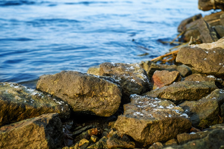 Stones lying on the bank of river in cold winterの写真素材
